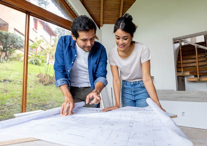 Couple looking at blueprints